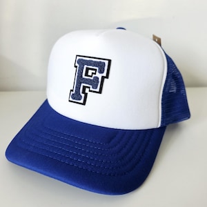 May include: White and blue trucker hat with a blue felt letter 'F' on the front.