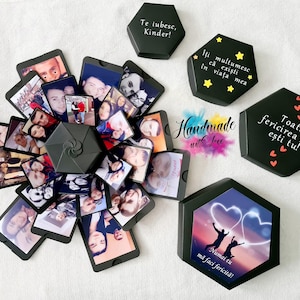 May include: A black explosion box with photos and messages inside. The box is open and the photos are visible. The box is decorated with stars and hearts. The text on the box says "Te iubesc, Kinder!" and "Iti multumesc ca exişti în viaţa mea". The text on the box also says "Toată fericirea mea eşti tu!" and "Numai tu mă faci fericită!"