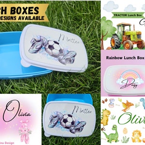 May include: A selection of personalised lunch boxes featuring a variety of designs. The lunch boxes are blue, pink and white with different themes including a football, a tractor, a rainbow, dinosaurs and a ballerina. The lunch boxes are personalised with names such as "Mattes", "George's", "Daisy", "Olivia" and "Oliver".