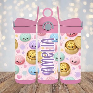 May include: A pink water bottle featuring a repeating pattern of cute, smiling bao buns in bamboo steamers, hearts, and stars on a light pink background. The name AMELIA is printed vertically in large, bold, purple letters on the center bottle.
