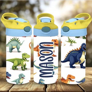 May include: Three water bottles with a white background and colorful dinosaur illustrations. Each bottle has a yellow flip-top lid with a blue accent. The name "MASON" is printed vertically on one bottle.