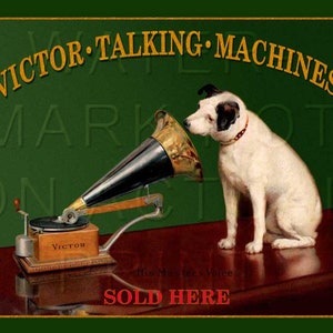 May include: A vintage advertisement for Victor Talking Machines. A white dog with black ears sits listening to a gramophone with a large horn. The text on the advertisement reads "Victor Talking Machines" and "Sold Here".