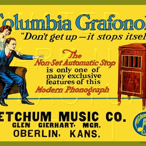 May include: A vintage advertisement for a Columbia Grafonola phonograph. The ad features a couple in a living room, with the man reaching out to turn off the phonograph. The text reads "Don't get up - it stops itself." The ad also highlights the "Non-Set Automatic Stop" feature of the phonograph. The ad is for Ketchum Music Co. in Oberlin, Kansas.