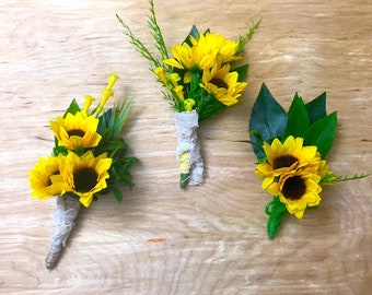 Boutonniere in yellow sunflowers for the groom, groomsman and grooms father. Flower for groom of rustic weddings and garden in summer.