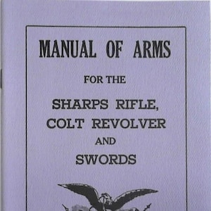 May include: A vintage manual titled "Manual of Arms" for Sharps Rifle, Colt Revolver, and Swords. The cover is light purple with black text and a detailed illustration of an eagle with a banner. The year 1861 is printed at the bottom.