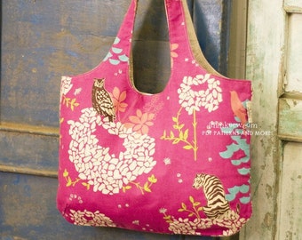 May include: A pink tote bag with a floral and animal print, including an owl and a tiger. The bag has a wide opening and long handles. The text "thinksew.com PDF PATTERNS AND MORE" is printed on the side.