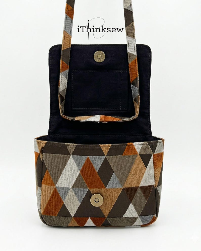 May include: Open, geometric-patterned handbag with a flap closure. The bag features a brown, gray, and orange triangle design on the exterior. The interior is black, and the strap is patterned. The text "iThinksew" is visible.