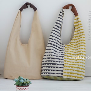 May include: Two beige and brown fabric tote bags with brown leather handles. The bag on the right has a black and yellow geometric pattern.