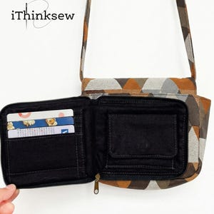 May include: Open, geometric-patterned wallet with a matching crossbody bag. The wallet is black inside with card slots and a small pocket. The exterior features a brown, orange, and gray triangle design. The brand name "iThinksew" is in the upper left corner.