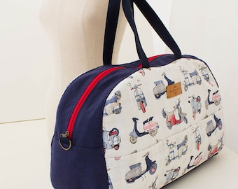 May include: A navy blue and white travel bag with a red zipper and a pattern of vintage scooters. The bag has a top handle and a label that says "MARVELOUS".
