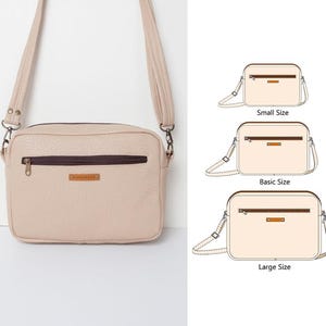 May include: A beige crossbody bag with a brown zipper and a brown leather strap. The bag is shown in three sizes: small, basic, and large. The bag is made of a textured material.
