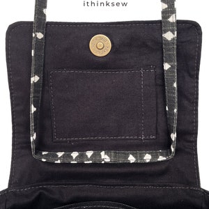 May include: Black fabric purse with a white diamond pattern on the strap and trim. The interior features a pocket and a magnetic snap closure. The text "ithinksew" is visible in the upper right corner.