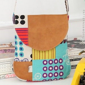 May include: A patchwork fabric crossbody bag with a brown leather flap. The bag has a variety of colorful patterns, including polka dots, stripes, and geometric shapes. The bag is closed with a magnetic snap.