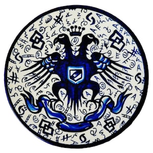 May include: A round ceramic plate with a blue and white design. The center features a double-headed eagle with a crown and a shield. The eagle is surrounded by a circle of stylized letters and symbols.