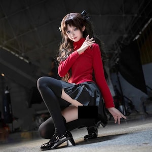 May include: A person in a cosplay outfit, wearing a red turtleneck, black skirt, and black tights. The person is also wearing black shoes with a small heel. The background is a dark, industrial setting.
