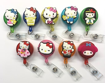 May include: Assortment of ten colorful retractable badge holders with cartoon character designs. The characters include Hello Kitty, My Melody, and other popular cartoon characters. Each holder features a different design and color.