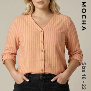 Plus-size model wearing a peach and orange striped V-neck button-down blouse with rolled sleeves. Represents a curvy fit PDF sewing pattern for women sizes 16 to 22 with long and folded sleeve options.