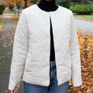 May include: A white quilted jacket with a button fastening. The jacket features a diamond-shaped quilting pattern.