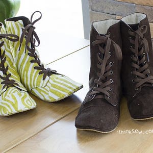 May include: Two pairs of lace-up boots. One pair is brown suede and the other pair is green and white with a zebra print.