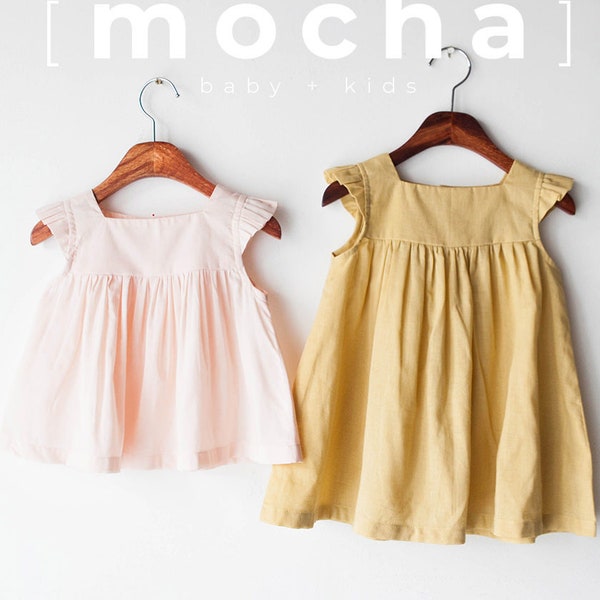 May include: Two sleeveless dresses hanging on wooden hangers. The dress on the left is a light pink color and the dress on the right is a light yellow color. Both dresses have a gathered skirt and ruffled sleeves.