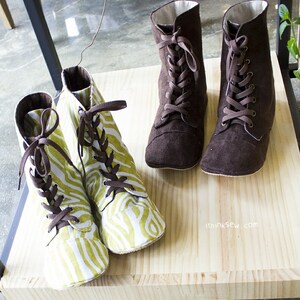 May include: Four pairs of brown and green lace-up boots. Two pairs are brown suede and two pairs are green and white patterned fabric. The boots are on a wooden shelf with the text "ithinksew.com" on the shelf.