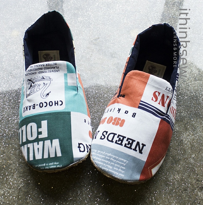 May include: A pair of blue, red, and white fabric slippers with a variety of text printed on them, including "Walking Fol", "Choco-Bake", "Needs 0350", and "Bakin'"