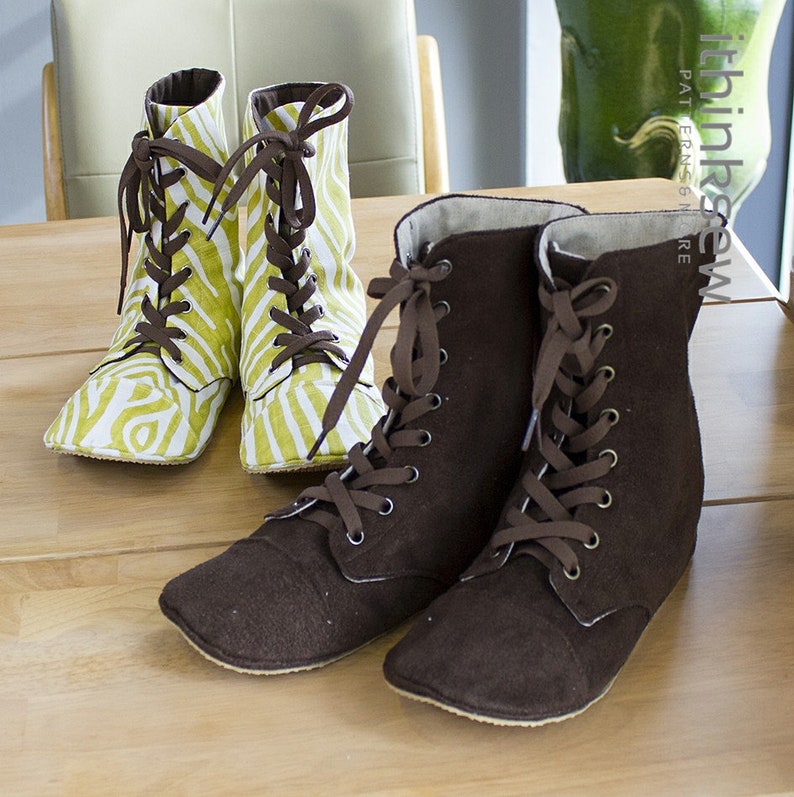 May include: Two pairs of lace-up boots. One pair is brown and the other pair is white and green with a striped pattern.