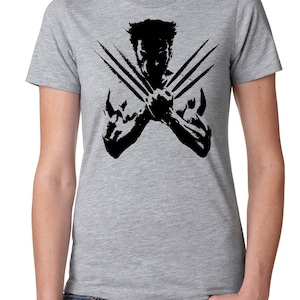 May include: A grey t-shirt featuring a black silhouette of Wolverine with his claws extended.