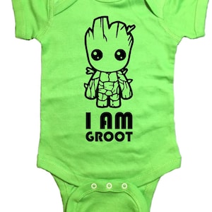 May include: A lime green baby onesie with a black cartoon image of Groot from Guardians of the Galaxy. The text "I AM GROOT" is printed below the image.