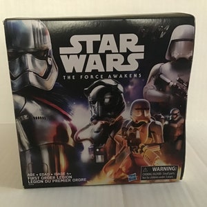 May include: A box for a Star Wars The Force Awakens First Order Legion toy set. The box features images of Stormtroopers, a TIE Fighter pilot, and a First Order officer. The box is black with red and white accents.