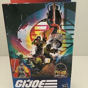 May include: A G.I. Joe Classified Series action figure box featuring the Python Crimson Guard. The box has a blue background with a colorful image of the action figure and other characters. The box also includes the Hasbro logo and the text "Python Patrol".