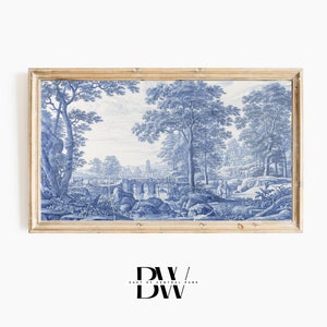 May include: A framed blue and white landscape painting depicting a river scene with a bridge, trees, and figures. The painting is in a light wood frame.