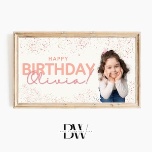 May include: A pink and white birthday banner with the text "Happy Birthday Olivia!" and a girl with a pink bow in her hair smiling at the camera.