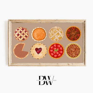 May include: A framed print showing eight different pie designs. The pies include a lattice-top berry pie, pumpkin pie, apple pie, chocolate pie with berries, a slice of pie, a heart-shaped jam pie, strawberry pie, and pecan pie. The frame is light brown.