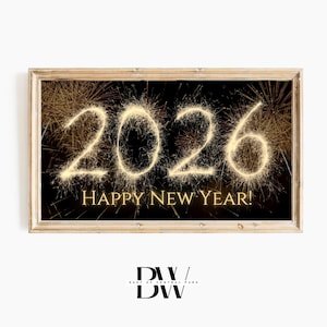 May include: A framed print with a black background and gold fireworks forming the number 2026. The words "HAPPY NEW YEAR!" are below the numbers. The frame is a light brown color.