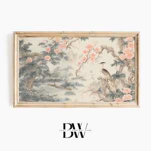 May include: A framed watercolor painting depicting a bird perched on a branch in a lush, floral landscape. The painting features delicate pink flowers, green foliage, and a light blue sky. The frame is a simple, light wood.