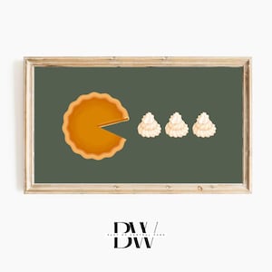 May include: A framed illustration of a pumpkin pie with a slice missing, and three small mounds of whipped cream.