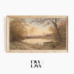 May include: A framed landscape painting showing a tranquil waterscape with trees in autumnal hues. The artwork features a pond reflecting the sky, set within a wooden frame. The painting evokes a sense of peace and natural beauty.