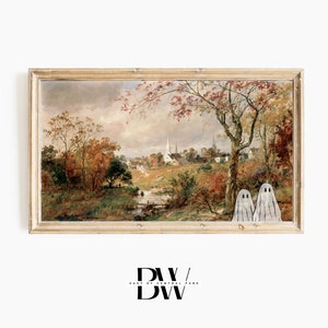 May include: A framed landscape painting with a vintage aesthetic, depicting a rural scene with a river, trees, and a church. Two cartoon ghosts are added to the bottom right corner. The frame is a light wood color.