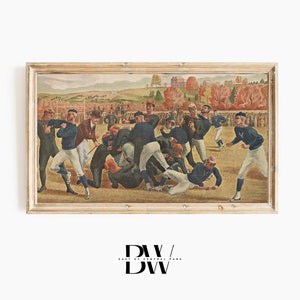 May include: A vintage framed painting depicting a football game in progress. The players are wearing blue and white uniforms and are in a huddle on a grassy field. The background shows a crowd of spectators and a distant cityscape.