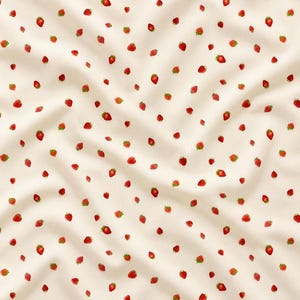 May include: A cream-colored fabric featuring a repeating pattern of small, red strawberries with green leaves. The material has soft folds and drapes, creating a textured surface that highlights the consistent distribution of the fruit print.