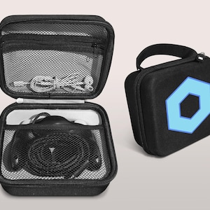 May include: Black zippered carrying case with a blue geometric design. The case is open, revealing headphones and a mesh pocket with cables. A second closed case with a handle and the same blue design is also shown.