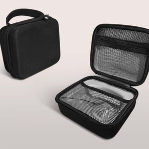 May include: Black, rectangular carrying case with a handle and zipper closure. The case is shown closed and open, revealing a mesh pocket and interior compartment. The open case has a gray interior.