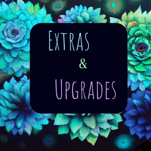 May include: A square, black graphic with the words "EXTRAS & UPGRADES" in light blue and purple. The background features a watercolor design of blue and green succulents.