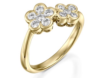 May include: A gold ring with two flower-shaped settings, each with five round diamonds.
