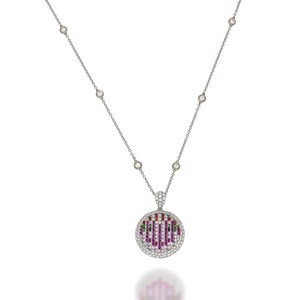 May include: A silver chain necklace with a round pendant featuring a colorful design of pink, red, and green gemstones set in a bed of white diamonds.