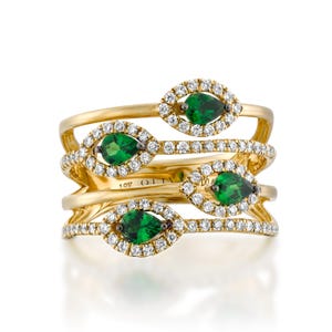 May include: A gold ring with four bands set with pear-shaped green gemstones surrounded by a halo of diamonds.