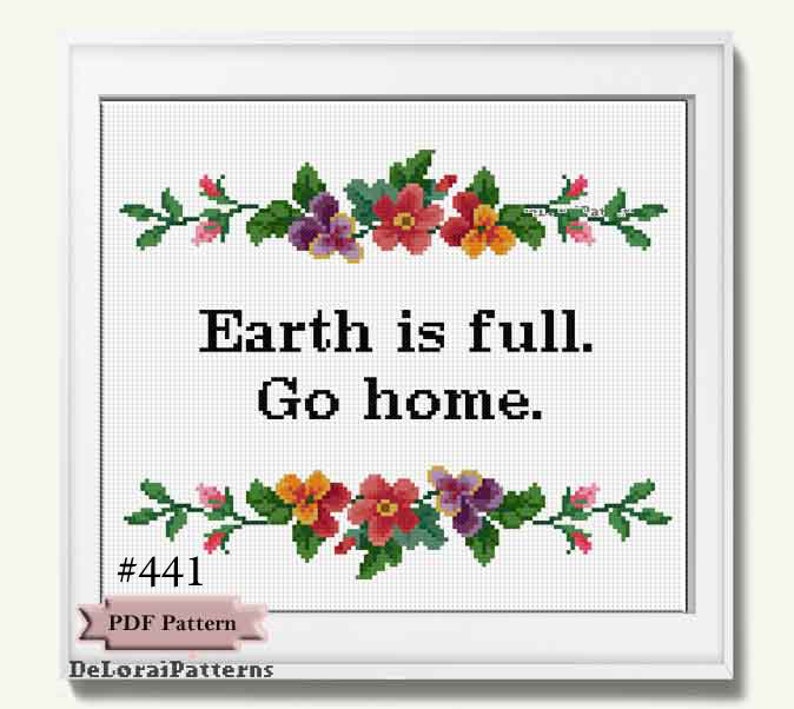 May include: A framed cross-stitch pattern with the text "Earth is full. Go home." The design features floral borders in red, orange, purple, and pink. The pattern is labeled "#441 PDF Pattern" and includes the designer's name.