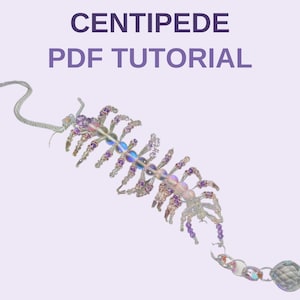 May include: A beaded centipede ornament featuring iridescent, purple, and clear glass beads with a faceted crystal sphere at the end. The text CENTIPEDE PDF TUTORIAL is displayed in purple above the beaded figure against a light background.