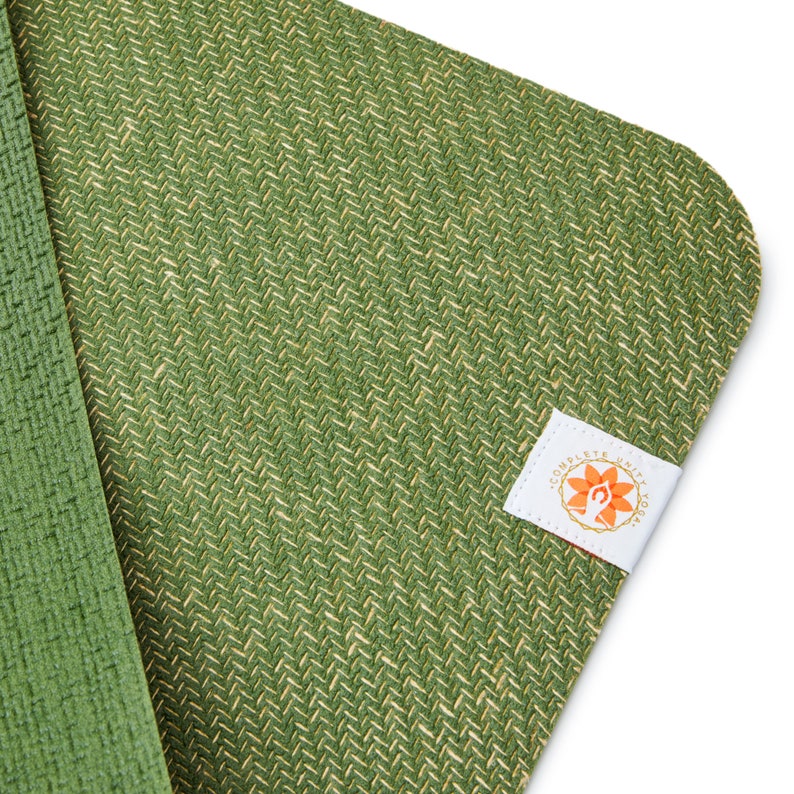 May include: Green yoga mat with a woven texture and a white label with the text "Complete Unity Yoga" and a stylized orange flower design.